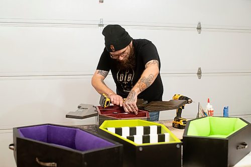 BROOK JONES / WINNIPEG FREE PRESS
Blake Locken, who works as a carpenter by day, runs a home-based business called Old Pine Box Curiousitiies. Locken is pictured working on a coffin shaped cabinet in his garage, which dubs as his workshop, in Winnipeg, Man., Wednesday, Oct. 11. He also builds upholstered pet beds and charcuterie boards, all with a coffin shape theme. The Winnipeg resident will be a vendor at the Punk Rock Flea Market at the University of Manitoba in Winnipeg, Man., Saturday, Oct. 14, 2023 from 10:30 a.m. to 5 p.m. The event also run Sunday, Oct. 15, 2023.