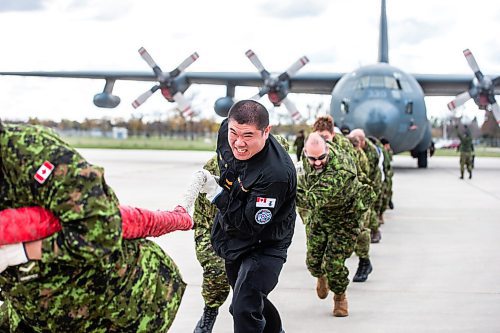 MIKAELA MACKENZIE / WINNIPEG FREE PRESS

Ling Yang (centre) and the MSS Warriors team pull the Herc in a plane pull event in support of United Way Winnipeg held at 17 Wing Winnipeg on Friday, Oct. 13, 2023. Standup.
Winnipeg Free Press 2023.