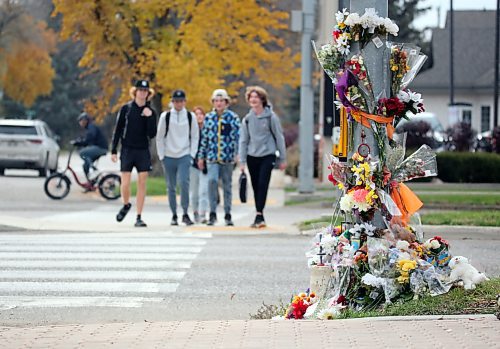 Students from Vincent Massey High School approach a memorial on Victoria Avenue to 15-year-old Vincent Massey student Antoine Sutherland, who was killed  in a vehicle-cyclist collision on Oct. 5 at the same crosswalk. (Photos by Matt Goerzen/The Brandon Sun)