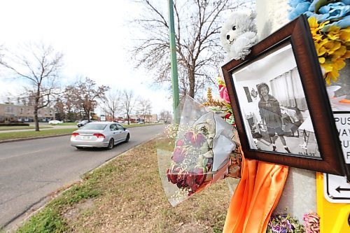 A westbound vehicle drives past a Victoria Avenue memorial to 15-year-old Antoine Sutherland, who was killed in a bike-vehicle collision at the same Victoria Avenue crosswalk. The memorial is made of flowers, photos, stuffed animals and other items as a remembrance of the Vincent Massey High School student. (Matt Goerzen/The Brandon Sun)