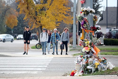 Students from Vincent Massey High School approach a memorial on Victoria Avenue to 15-year-old Vincent Massey student Antoine Sutherland, who was killed  in a vehicle-cyclist collision on Oct. 5 at the same crosswalk. (Matt Goerzen/The Brandon Sun)