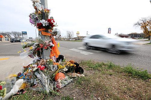 A westbound vehicle travels past a memorial on Victoria Avenue to 15-year-old Vincent Massey student Antoine Sutherland, who was killed  in a vehicle-cyclist collision on Oct. 5 at the same crosswalk. (Matt Goerzen/The Brandon Sun)
