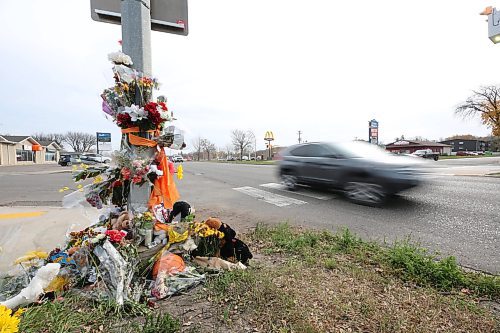 A westbound vehicle travels past a memorial on Victoria Avenue to 15-year-old Vincent Massey student Antoine Sutherland, who was killed  in a vehicle-cyclist collision on Oct. 5 at the same crosswalk. (Matt Goerzen/The Brandon Sun)