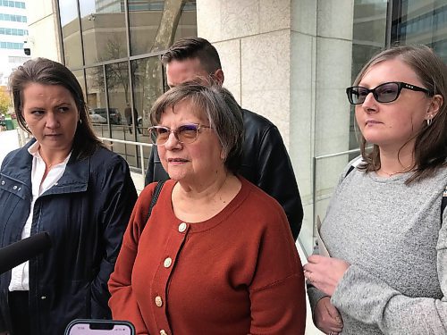 Candyce Szkwarek (centre) speaks to reporters outside court Tuesday after a judge declared her attacker Trevor Farley not criminally responsible for his actions. (Dean Pritchard/Winnipeg Free Press)