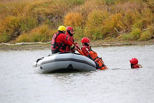 Dressed in water training immersion suits, students from the Manitoba Emergency Services College in Brandon undergo surface water rescue education in the Assiniboine River as part of their course work at Dinsdale Park on Wednesday afternoon. (Matt Goerzen/The Brandon Sun)