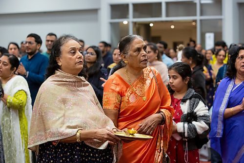BROOK JONES / WINNIPEG FREE PRESS
Members of the Hindu community gather on the fourth day of the Sharadiya Navratri Festival, which celebrates the nine forms of the Hindu Goddess Durga at the Hindu Temple and Dr. Raj Pandey Cultrual Centre in Winnipeg, Man., Wednesday, Oct. 18, 2023. Pictured: Pusxpa Patel (right) and her friend Sarle Patel are both performing Artie, which is the final offering to the Hindu Goddess of Durga. On the fourth day of the festival, the Goddess of Durga is known as Kushmanda.