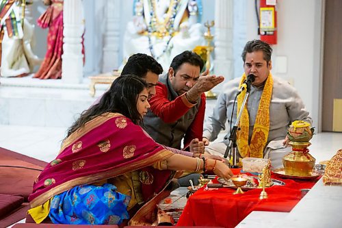 BROOK JONES / WINNIPEG FREE PRESS
Members of the Hindu community gather on the fourth day of the Sharadiya Navratri Festival, which celebrates the nine forms of the Hindu Goddess Durga at the Hindu Temple and Dr. Raj Pandey Cultrual Centre in Winnipeg, Man., Wednesday, Oct. 18, 2023. Pictured: Pandit Shrikant Sharma (second from right) and Pandit Vimlesh Jha (far right), who are priests with the Hindu Society of Manitoba, lead Anand Amin (second from left) and Shivani Patel (far left) in performing Lakshmi Mata Puja, which is also known as an offering to the Goddess Durga, who is in the form of Kushmanda on the fourth day of the festival, in front of the altar.