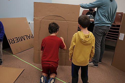 Some of the children building a watch tower with cardboard on Friday. (Abiola Odutola/The Brandon Sun)