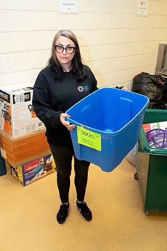 BROOK JONES / WINNIPEG FREE PRESS
Main Street Project Communications Specialist Cindy Titus holding an empty bin for socks at the local shelter's clothing donation area in Winnipeg, Man., Friday, Oct. 20, 2023. Main Street Project is collecting donations of socks for its Socktober campaign. The shelter also needs donations of everyday clothing items and with cooler weather approaching, donations of thermal wear, winter boots, winter coats and jackets, snow pants, scarves and hand warmers are also in need.