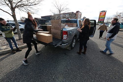 Premier Truck team offloading donations from Food Rescue's Truck. (Abiola Odutola/The Brandon Sun)