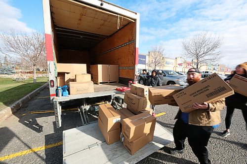 Premier Truck team loading donations from Food Rescue's Truck. (Abiola Odutola/The Brandon Sun)