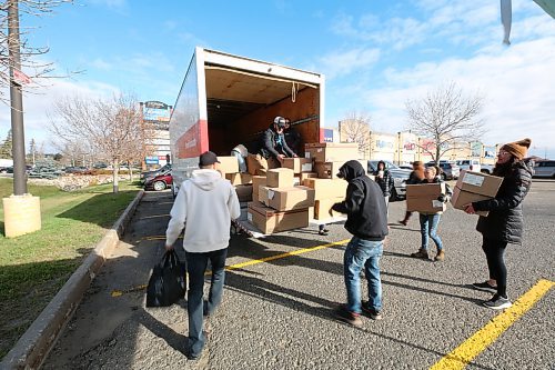 Premier Truck team loading donations from Food Rescue's Truck. (Abiola Odutola/The Brandon Sun)