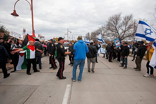 JOHN WOODS / WINNIPEG FREE PRESS
Police step in as Israeli supporters retrieve a flag taken by Palestinian supporters as both sides gather outside the Canadian Museum for Human Rights in Winnipeg Sunday, October 22, 2023. 

Reporter: searle