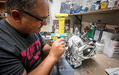 JOHN WOODS / WINNIPEG FREE PRESS
Tony Bage, founder of Wicked Goalie, works on his latest creation in his home studio in Winnipeg Monday, October 23, 2023. Bage has been airbrushing hockey masks and other things like motorcycles for close to 30 years.

Reporter: sanderson