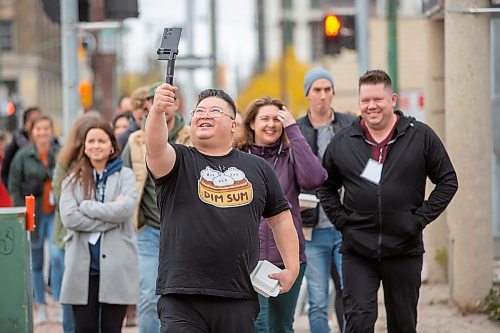 BROOK JONES / WINNIPEG FREE PRESS
Forty-one-year-old Carter Chen taking a selfie as he leads the Chinatown Dim Sum Tour in Winnipeg, Man., on the afternoon of Saturday, Oct. 21, 2023. Chen, who has his very own Dim Sum T-shirt, is pictured just before arriving at Dim Sum Garden at 245 King St., which was one of two stops on the tour. The other location was Sam Po Restaurant at 277 Rupert Ave. Twenty people attended the tour. 