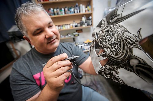 JOHN WOODS / WINNIPEG FREE PRESS
Tony Bage, founder of Wicked Goalie, works on his latest creation in his home studio in Winnipeg Monday, October 23, 2023. Bage has been airbrushing hockey masks and other things like motorcycles for close to 30 years.

Reporter: sanderson