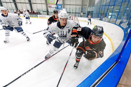 MIKE DEAL / WINNIPEG FREE PRESS
Winkler Flyers&#x2019; Nicholas McKee (28) and Dauphin Kings&#x2019; Anthony Bax (7) grind it out in the corner for the puck during game action at the Seven Oaks Sportsplex Tuesday afternoon.
See Mike Sawatzky story
231024 - Tuesday, October 24, 2023.