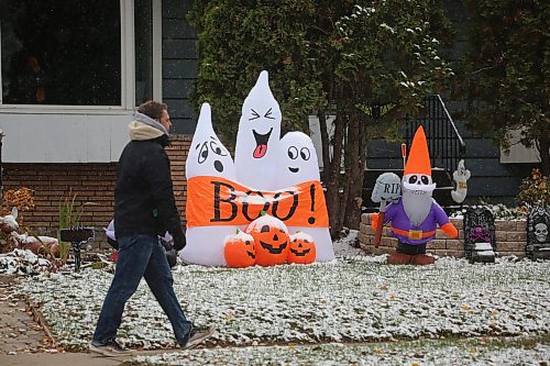 A man walks past a Halloween display on First Street in Brandon on Wednesday afternoon. (Matt Goerzen/The Brandon Sun)