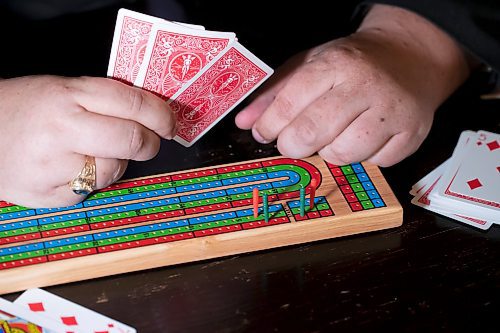 BROOK JONES / WINNIPEG FREE PRESS
Thirty-five-year-old Lyndon Demers, who is passionate about cribbage, showcases a cribbage board as he hosts Lyndon's Cribbage Nights every second Wednesday from 6:30 to 9 p.m. on the second floor of Heather Curling Club at 120 Youville Street. As many as 20 enthusiatic cribbage players gather for the cribbage nights, rotating opponents as the evening goes along. Demers was pictured at the Heather Curling Club in Winnipeg, Man., Wednesday, Oct. 25, 2023.