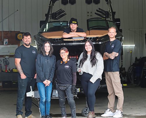 Darren Darvill (far right), the owner and operator of Resurrection Auto Detailing Tint and Protection, poses for a photo with his staff in Brandon on Thursday. From left, Matt Ross, Lainey Fidler, Shawn Simpson, Jordan Bedford, with Zach Heidie in the boat. (Michele McDougall/The Brandon Sun)