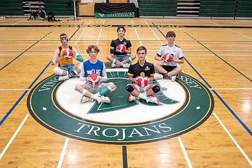 BROOK JONES / WINNIPEG FREE PRESS
The Institut Coll&#xe9;gial Vincent Massey Collegaite Trojans varsity boys volleyball team is undefeated as of Oct. 26. Pictured left to right: Grade 12 players Morgan Eby, Keon Torz, Everett Smith, Mitchell Strilchuk and Shay McKim sitting with volleyballs during a team practice at the school's gym in Winnipeg, Man., Thursday, Oct. 26. 2023. Missing: Grade 12 player Owen Weekes.