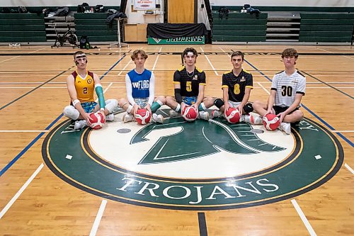 BROOK JONES / WINNIPEG FREE PRESS
The Institut Coll&#xe9;gial Vincent Massey Collegaite Trojans varsity boys volleyball team is undefeated as of Oct. 26. Pictured left to right: Grade 12 players Morgan Eby, Keon Torz, Everett Smith, Mitchell Strilchuk and Shay McKim sitting with volleyballs during a team practice at the school's gym in Winnipeg, Man., Thursday, Oct. 26. 2023. Missing: Grade 12 player Owen Weekes.