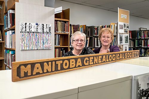 BROOK JONES / WINNIPEG FREE PRESS
Gloria McNabb (left) and Daryl Dumanski are volunteers with the Manitoba Genealogical Society. The duo are pictured next to the society's wooden sign from its founding year in 1976. McNabb has been volunteering for the local charity for five years. Dumanski has been volunteering for nearly 40 years.