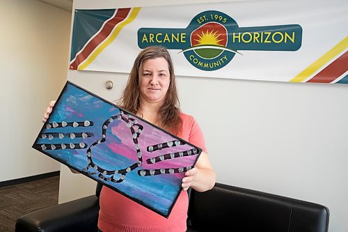 BROOK JONES / WINNIPEG FREE PRESS.
Linsay Skipp is one of six Arcane artists, who is part of the Artbeat Artist Group. The 44-year-old is pictured holding one of her paintings called Love Heart, while at Arcane Horizon Community in Winnipeg, Man., Friday, Oct. 27, 2023. Arcane Horizon Community and Lennard Taylor Design Studio are hosting its inaugrual art gala fundraiser one the fifth floor of 290 McDermot Ave., from 6 to 9:30 p.m., Saturday, Nov. 18, 2023.
