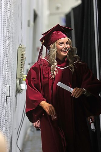 Assinboine Community College graduate Kelsea Harder, from Morden, carries her degree while walking behind a curtain on her way back to her seat during a graduation ceremony at the Keystone Centre's Manitoba Room on Friday afternoon. (Matt Goerzen/The Brandon Sun) 