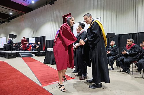 Brian Cox, chair of the Early Childhood Education program at Assiniboine Community College, congratulates Sukhpreet Kaur on earning her Office Skills certificate during a graduation ceremony held at the Keystone Centre's Manitoba Room on Friday afternoon. (Matt Goerzen/The Brandon Sun)