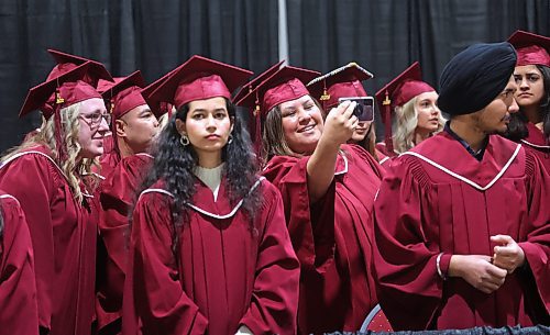 A graduating Assiniboine Community College student takes one last selfie with her fellow students before receiving her degree during Friday's graduation ceremony at the Keystone Centre's Manitoba Room. (Matt Goerzen/The Brandon Sun)