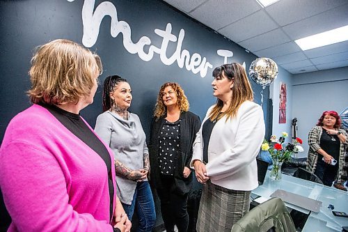 MIKAELA MACKENZIE / WINNIPEG FREE PRESS

Michele Wikkerink (executive director of the Spence Neighbourhood Association, left), Della Steinke (tattoo removal artist and mentor), Michelle de Groot (WPS gang prevention coordinator), and Bernadette Smith (NDP minister) chat after the Mother Ink Tattoo Removal grand opening on Friday, Oct. 27, 2023. For Erik story.
Winnipeg Free Press 2023.