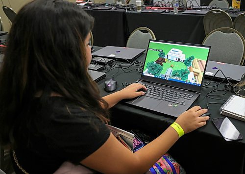 RUTH BONNEVILLE / WINNIPEG FREE PRESS

Local - FIRST NATION ESPORTS

Photo of first place winner, grade 9 student, Naeyli Desjarlais, from Brokenhead First Nation, showing her work.  

FIRST NATION ESPORTS: The Manitoba First Nations School System is putting on an Indigenous design challenge with Minecraft Ed in Manitoba's  first fully Indigenous esports tournament at the Convention Centre Friday.  Esports clubs have been surging in popularity owing to a number of passionate teachers across the province. 

See Maggie's story. 

October 27th. 2023

October 27th, 2023