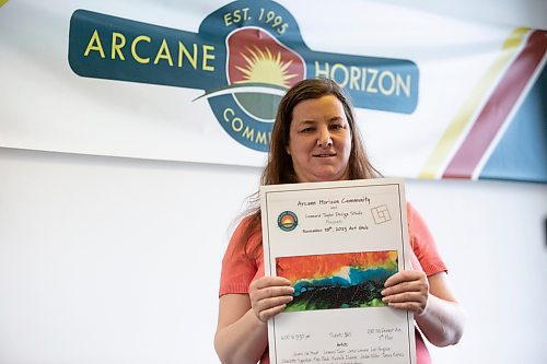 BROOK JONES / WINNIPEG FREE PRESS.
Linsay Skipp is one of six Arcane artists, who is part of the Artbeat Artist Group. The 44-year-old is pictured holding a promotional poster for an upcoming art gala, while at Arcane Horizon Community in Winnipeg, Man., Friday, Oct. 27, 2023. Arcane Horizon Community and Lennard Taylor Design Studio are hosting its inaugural art gala fundraiser one the fifth floor of 290 McDermot Ave., from 6 to 9:30 p.m., Saturday, Nov. 18, 2023.