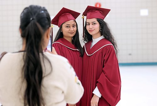 Raman Sandu takes a picture of Assiniboine Community College students Himani Himani, left, and Harnoor Brar shortly before their graduation ceremony on Friday afternoon at the Keystone Centre's Manitoba Room. The two women earned an advanced diploma in Sustainable Food Systems from the college. (Matt Goerzen/The Brandon Sun) 
