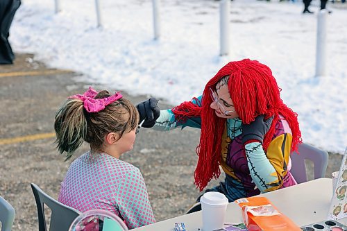 Ray Shachtay carefully decorates a girl's face at Calvary Temple's Halloween Parking Lot Party on Sunday afternoon. On top of playing games and getting treats, visitors were encouraged to bring donations for Samaritan House Ministries' food bank. (Colin Slark/The Brandon Sun)