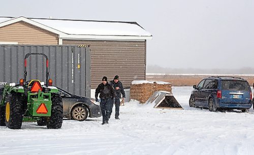 Officers with Prairie Bylaw Enforcement leave the entrance of a mobile home at the property of Zak McDermot-Fouts in the RM of Whitehead on Monday. (Matt Goerzen/The Brandon Sun)