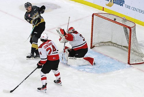 Prince George Cougars goaltender Ty Young (33) and defenceman Keaton Dowhaniuk (24), along with Brandon Wheat Kings forward Roger McQueen (13), watch as the puck goes high over the net during a Brandon power play in Western Hockey League action at Westoba Place on Wednesday evening. (Perry Bergson/The Brandon Sun)