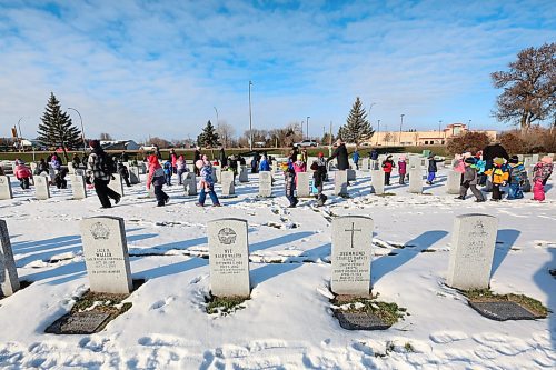 Children from various schools in the Brandon School Division walk along the gravesides of former Canadian Forces service men and women at the Brandon Municipal Cemetery on Friday morning. The children were tasked with placing a poppy on every military stone as a remembrance of their service to their country. (Matt Goerzen/The Brandon Sun)