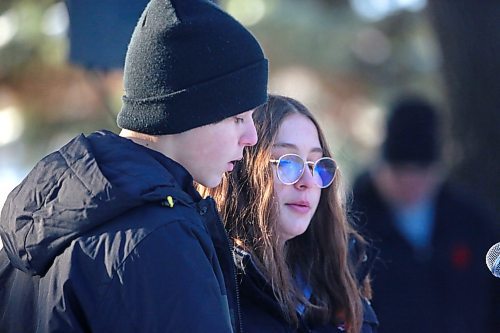 Riverheights School Grade 8 students Valentyne Gasuliak, left, and Aubreigh Atchison read the "Commitment to Remember" during the No Stone Left Alone event at the Brandon Municipal Cemetery on Friday morning. (Matt Goerzen/The Brandon Sun)