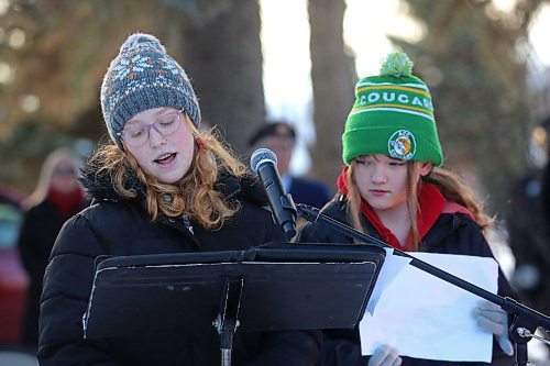 Rowan Little, left, and Astrid Seeland from cole Harrison read solidiers' wartime letters during the No Stone Left Alone ceremony at the Brandon Municipal Cemetery on Friday morning. (Matt Goerzen/The Brandon Sun)