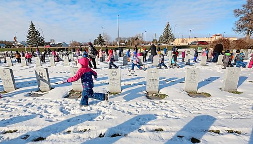 Children from various schools in the Brandon School Division move along the gravesides of former Canadian Forces service men and women following the No Stone Left Alone ceremony at the Brandon Municipal Cemetery on Friday morning. The children were tasked with placing a poppy on every military stone as a remembrance of their service to their country. (Matt Goerzen/The Brandon Sun)
