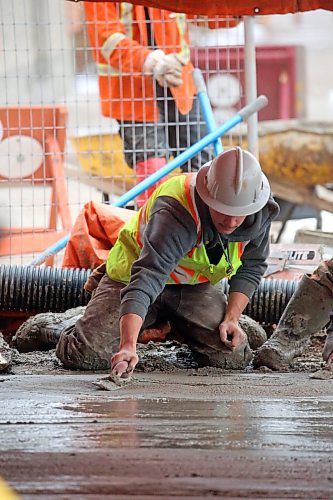 Ben Wiebe Construction employee Cole Lockhart smooths out a newly-poured sidewalk in the 1200 block of Rosser Avenue on Friday afternoon. (Matt Goerzen/The Brandon Sun)