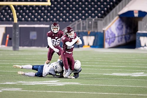 BROOK JONES / WINNIPEG FREE PRESS
The Grant Park High School Pirates claimed a 24-21 victory over the St. Paul's High School Crusaders in the Winnipeg High School Football League AAAA Conference (top bracket) semi-final of the ANAVETS Bowl at IG Field in Winnipeg, Man., Friday, Nov. 3,. 2023. Pictured: St. Paul's Crusaders running back Liam Cantafio runs with the football as the tries to escape being tackled by two Grant Park Pirates defenders during second quarter action.