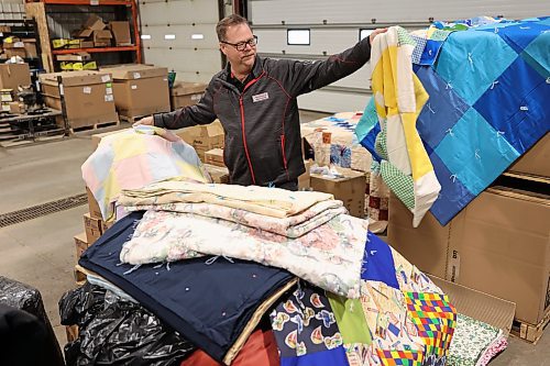 Dwayne Stone, branch manager at Premier Truck Group in Brandon, holds up some of the blankets that were donated during the one-day fundraising blitz called Fill the Freightliner, held in October. (Michele McDougall/The Brandon Sun)

