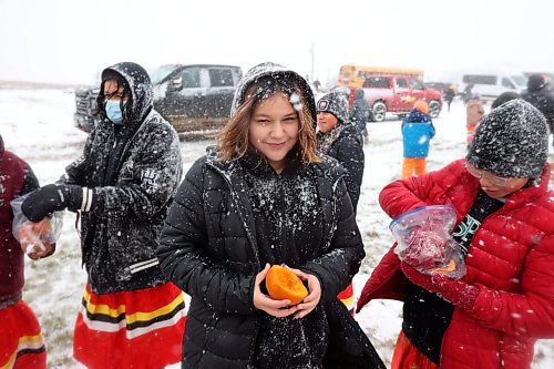 07112023
Students from Sioux Valley Elementary School and Sioux Valley High School feed pumpkins to Sioux Valley Dakota Nation’s herd of bison during the Honouring the Buffalo event in the community during a snow storm on Tuesday. The students and other members of the community gave pumpkins to the bison to eat and learned about the importance of bison in Dakota traditions and how bison protect one another. A lunch followed at the SVDN Veteran’s Hall. 
(Tim Smith/The Brandon Sun)