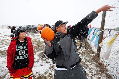 07112023
Sioux Valley High School student Bradley Bone winds up to throw a piece of pumpkin to Sioux Valley Dakota Nation’s herd of bison during the Honouring the Buffalo event in the community amid a snow storm on Tuesday. Sioux Valley elementary and high school students and other members of the community gave pumpkins to the bison to eat and learned about the importance of bison in Dakota traditions and how bison protect one another. A lunch followed at the SVDN Veteran’s Hall. 
(Tim Smith/The Brandon Sun)