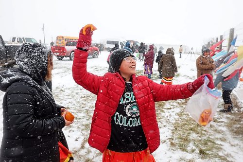 07112023
Grade six student Jada Ironman winds up to throw a piece of pumpkin to Sioux Valley Dakota Nation&#x2019;s herd of bison during the Honouring the Buffalo event in the community amid a snow storm on Tuesday. Sioux Valley elementary and high school students and other members of the community gave pumpkins to the bison to eat and learned about the importance of bison in Dakota traditions and how bison protect one another. A lunch followed at the SVDN Veteran&#x2019;s Hall. 
(Tim Smith/The Brandon Sun)