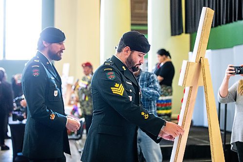 MIKAELA MACKENZIE / WINNIPEG FREE PRESS

Sargent Nathan Bonkowski pins a poppy to a cross at the 27th Annual Indigenous Veterans&#x560;Day Ceremony at Neeginan Centre on Wednesday, Nov. 8, 2023. For Erik story.
Winnipeg Free Press 2023.