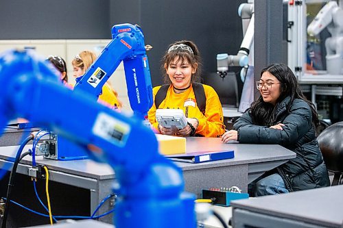 MIKAELA MACKENZIE / WINNIPEG FREE PRESS

Diamond Desmarais (left) and Sam Junio, grade 10 and 11 Tech Voc students, learn how to control an industrial robot arm in the robotics lab at the Jill of All Trades event (which encourages girls to enter the trades) on Wednesday, Nov. 8, 2023. For Maggie story.
Winnipeg Free Press 2023.